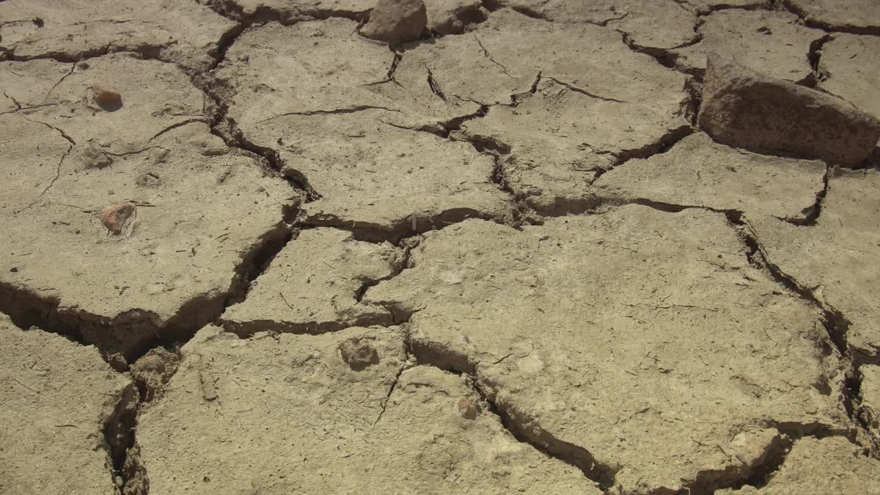 特写破碎的地面由干旱的夏季炎热干燥的土壤在变暖危机中显示全球缺水的星球和气候变化视频素材