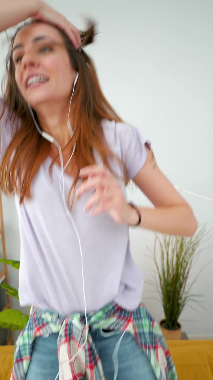 快乐的女人在家里跳舞。视频素材