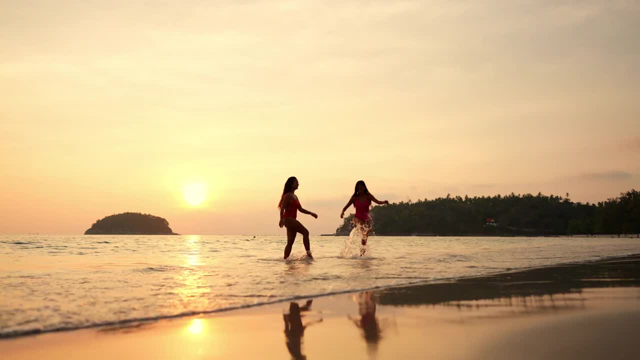 一群亚洲女性朋友一起在热带海滩玩海水视频素材