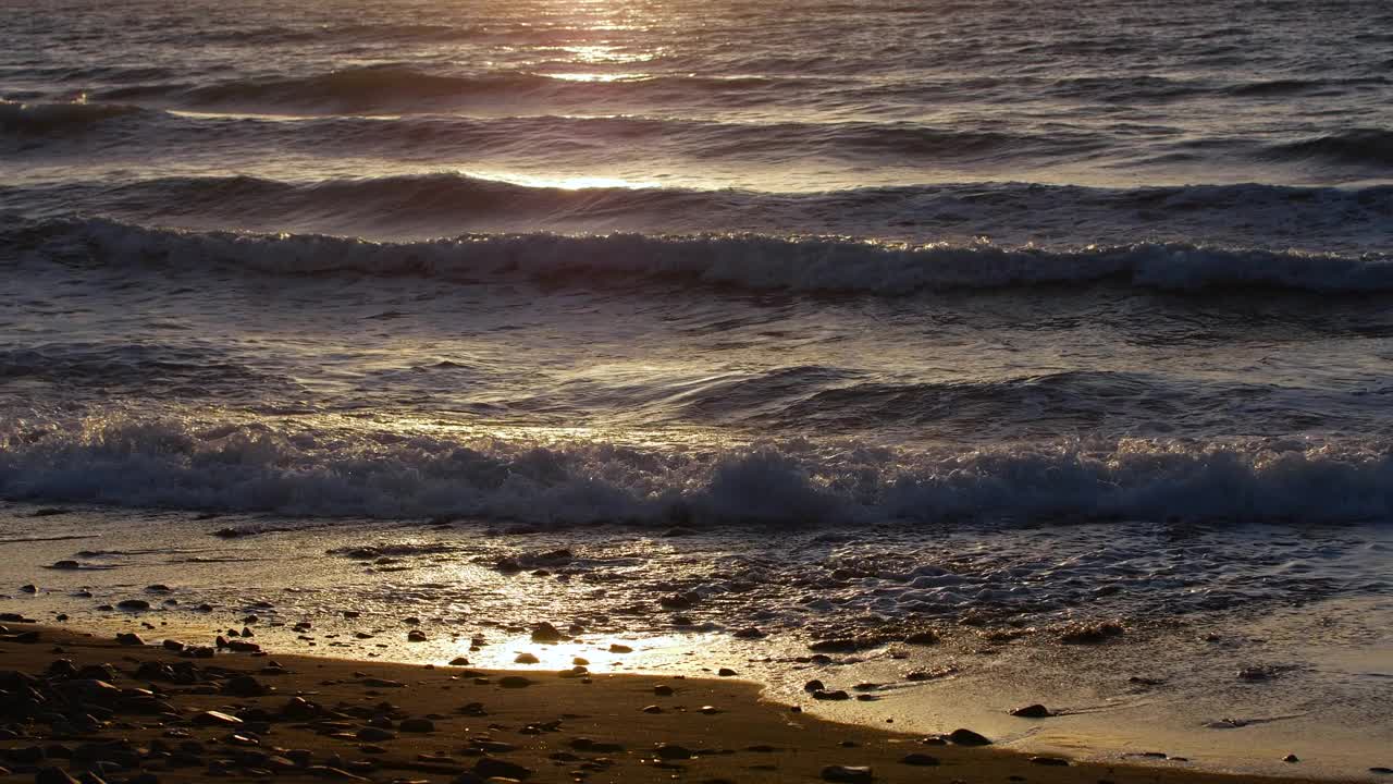 暴风雨的大海日落，自然戏剧性的海景。日落或日出的阳光透过金色的波浪视频素材