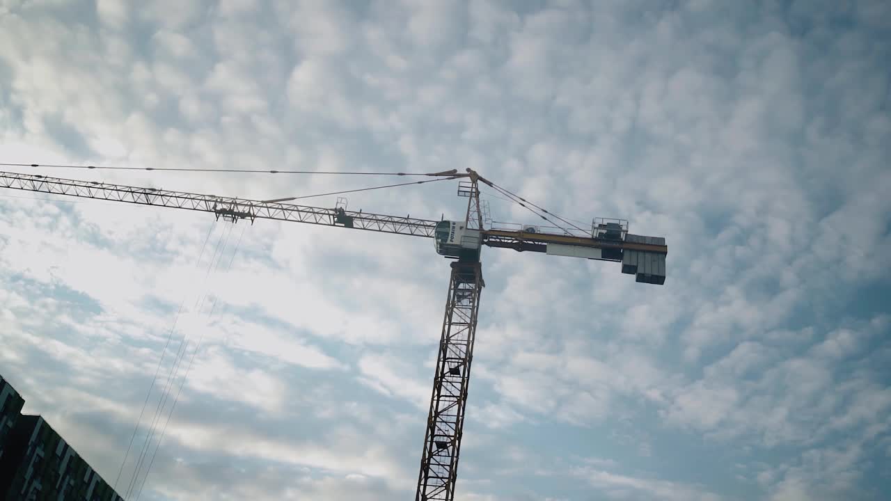 蓝天白云背景下的高大建筑起重机。拍摄施工现场视频素材