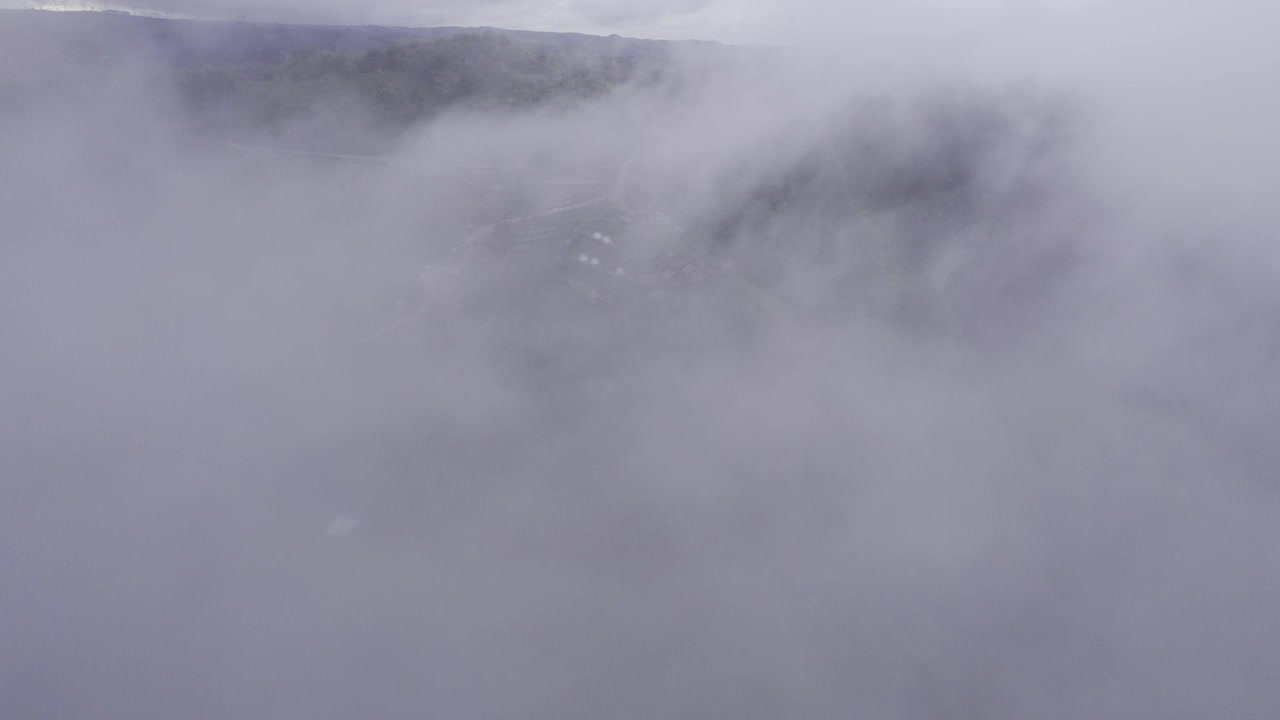 鸟瞰图，飞越雾蒙蒙的小木屋在山上的乡村视频素材