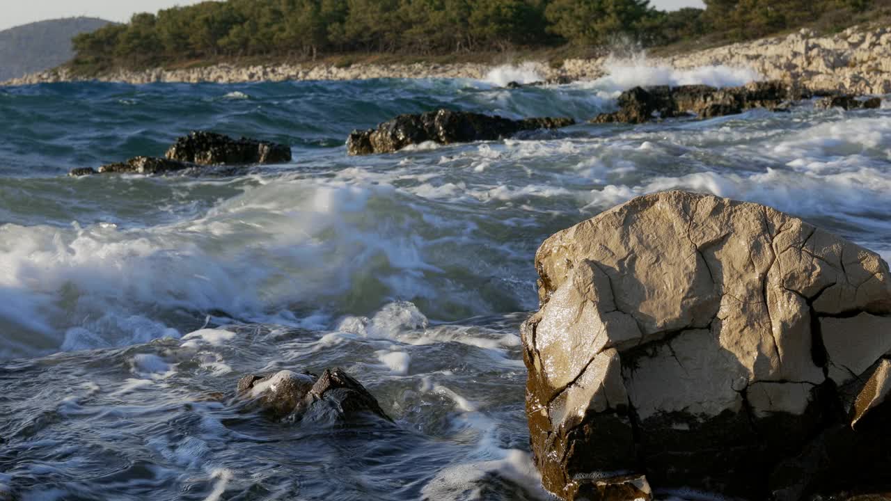 日落时海浪拍打着岩石视频素材