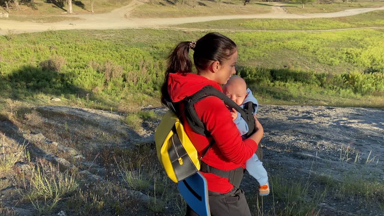 母亲带着宝宝在户外旅行，享受美景，家庭积极健康的生活方式，带着孩子的妇女，在俄罗斯克里米亚度假。视频素材