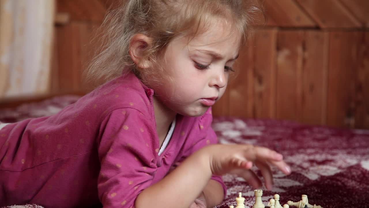 小女孩在床上玩棋子视频素材