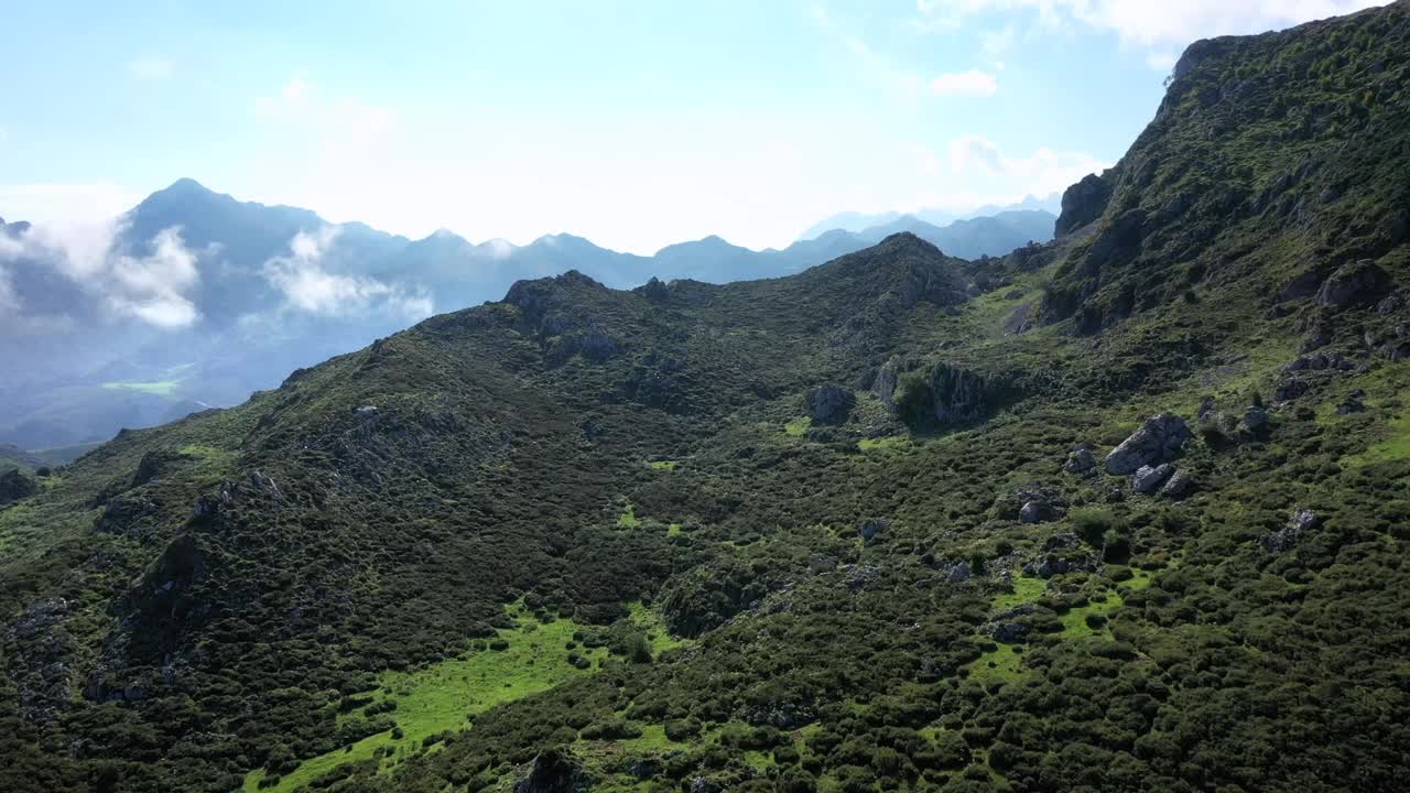 俯瞰绿色的山脉，朝着明亮的蓝天，在欧洲国家公园的山峰，阳光明媚的夏天，在西班牙的阿斯图里亚斯-上升的镜头视频素材