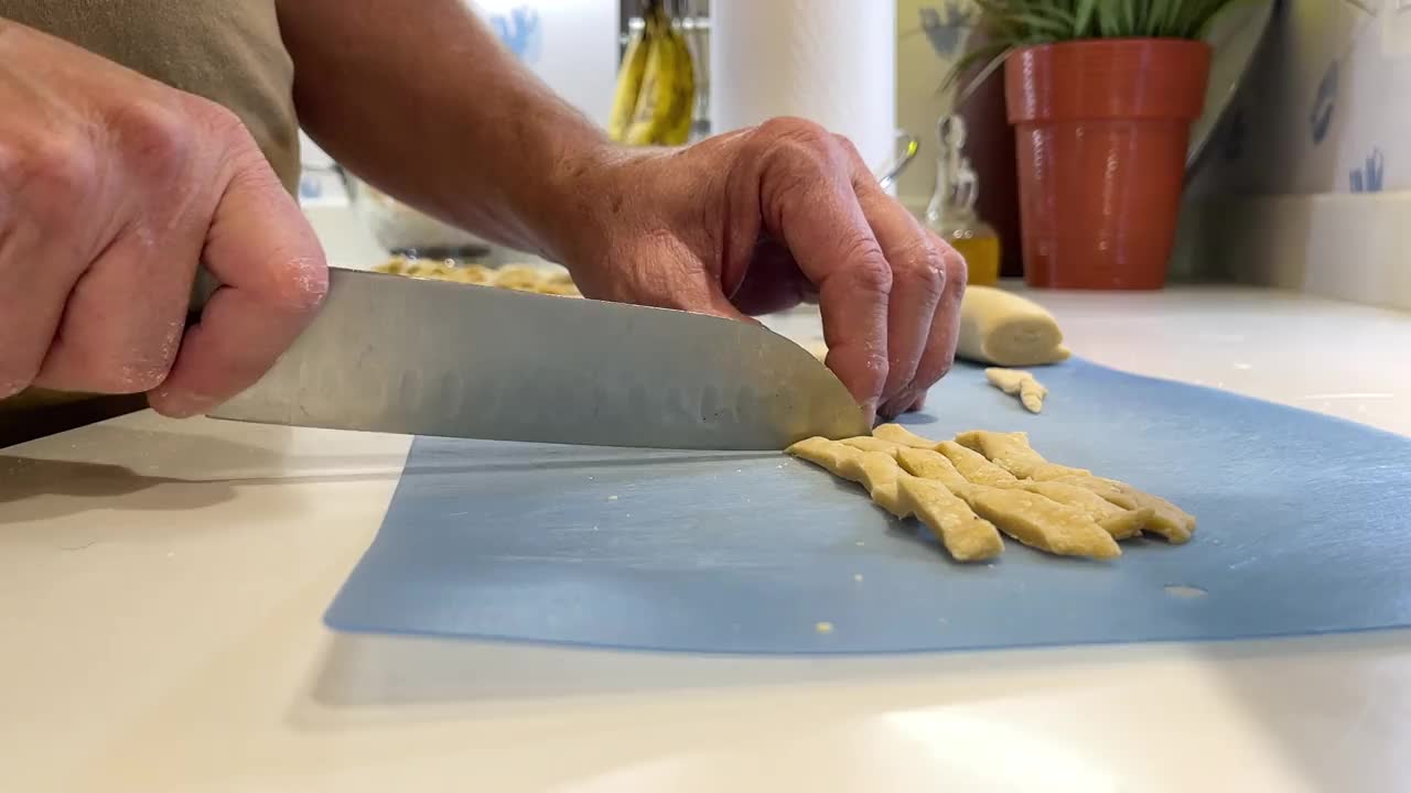 家庭厨房慢动作视频系列中，男厨师为鸡肉面汤准备面条视频素材