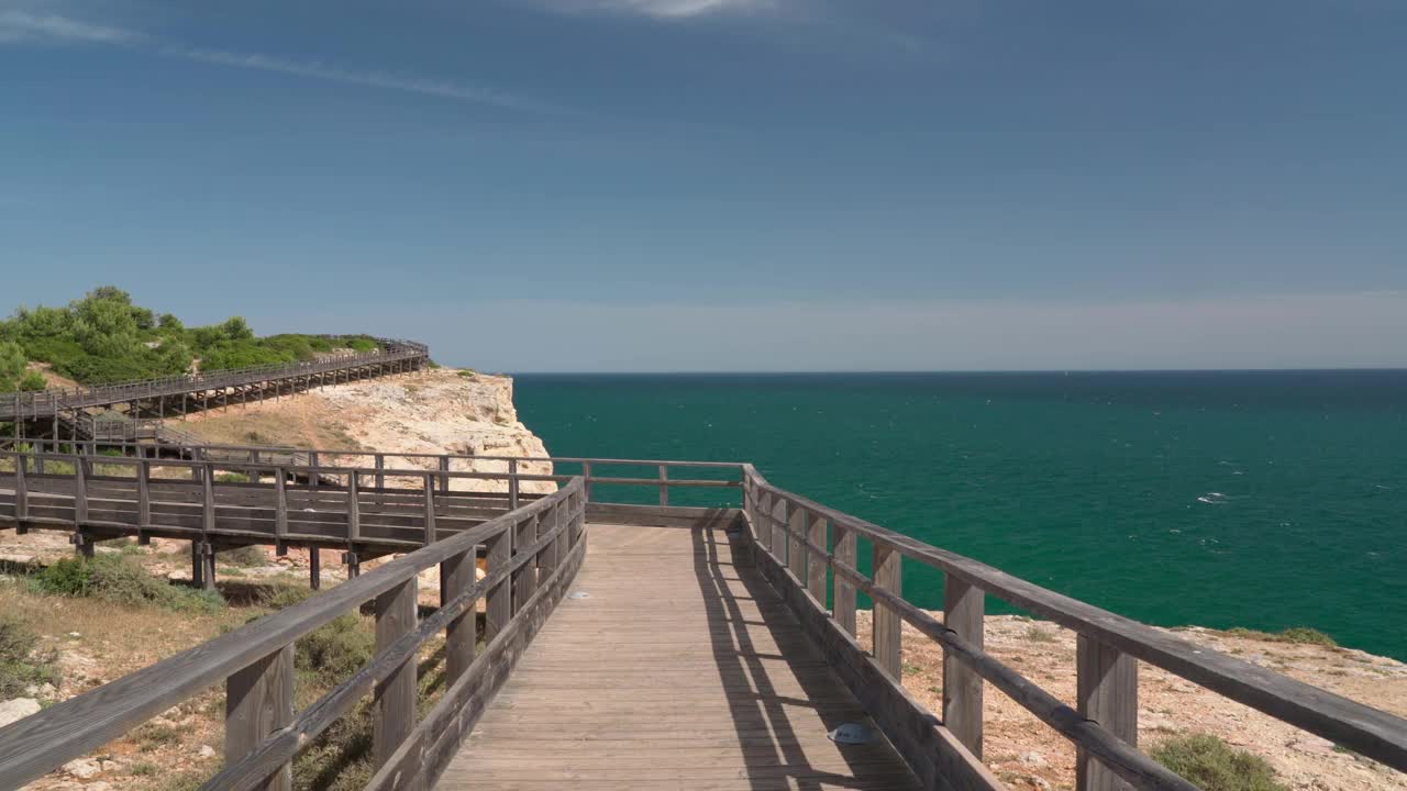 沿着木路散步，你会看到夏天葡萄牙卡沃埃罗海岸的美妙景色。俯瞰蓝色的大海。用稳定器在运动中射击。视频素材