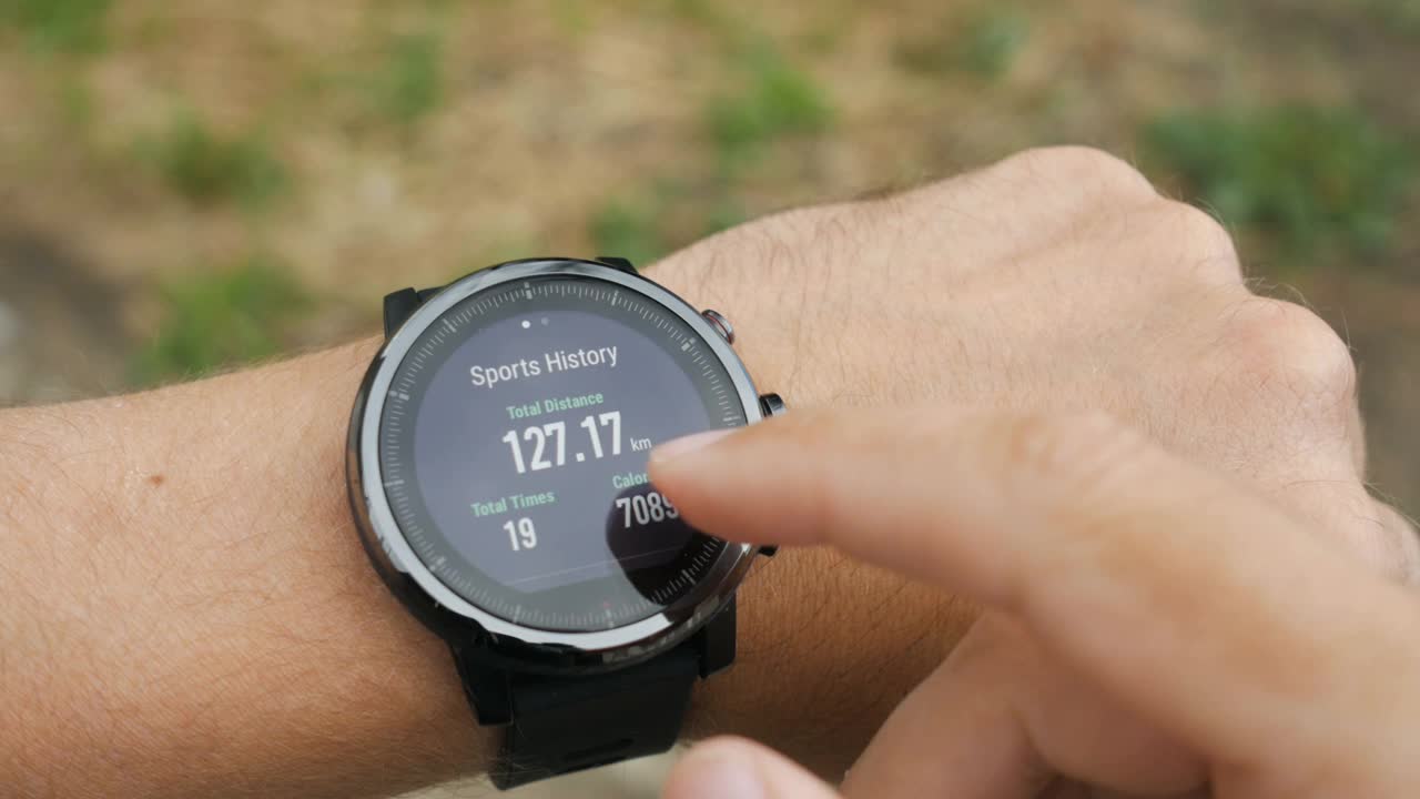 在智能手表上跑步训练的结果。Smartwatch。手拿显示训练结果的运动手表。脉搏，速度，距离，卡路里视频素材