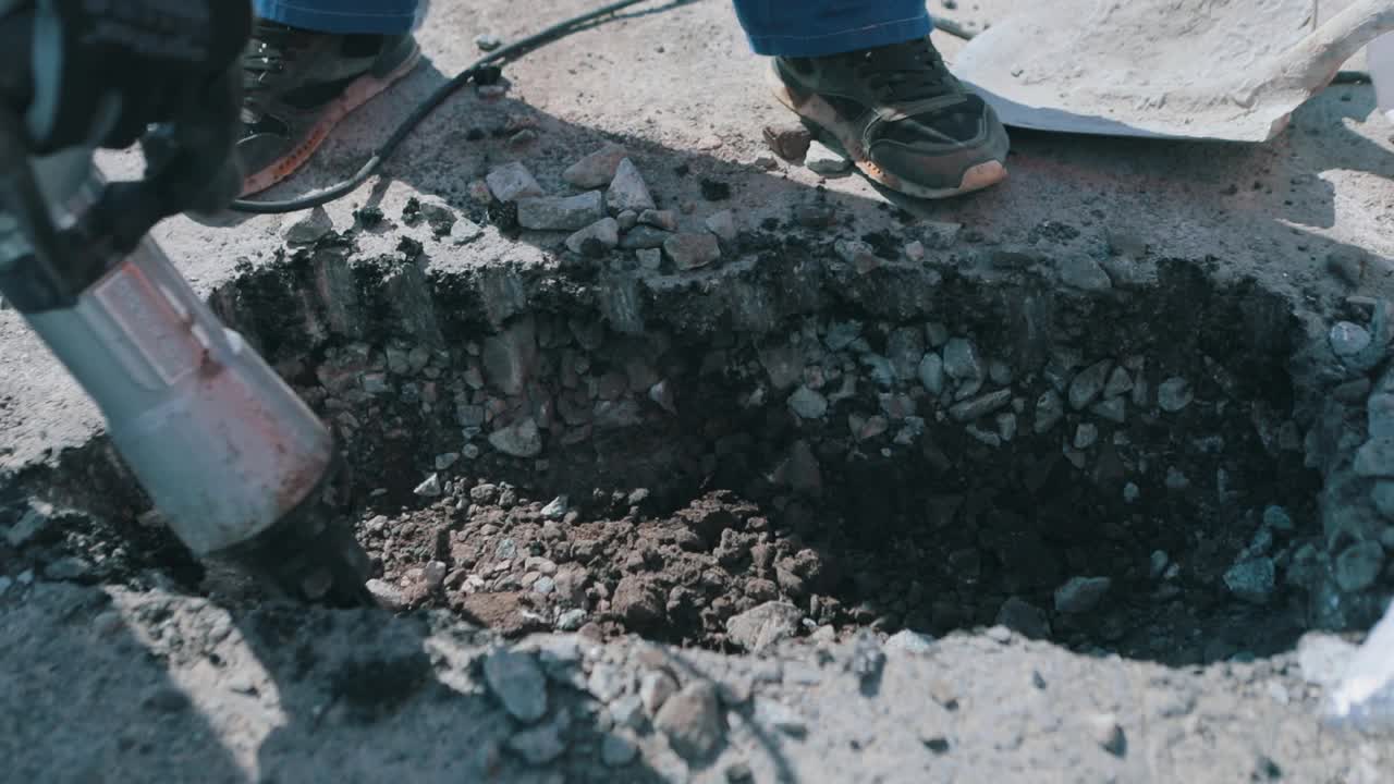 手提钻破坏了沥青。道路工程特写。手提钻近了。用手提钻拆除沥青视频素材