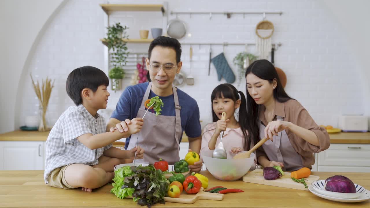 假日一家人在厨房一起做午餐。视频素材