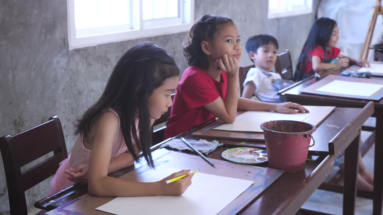 一群在家里或小学用铅笔在纸上画画的亚洲孩子视频素材