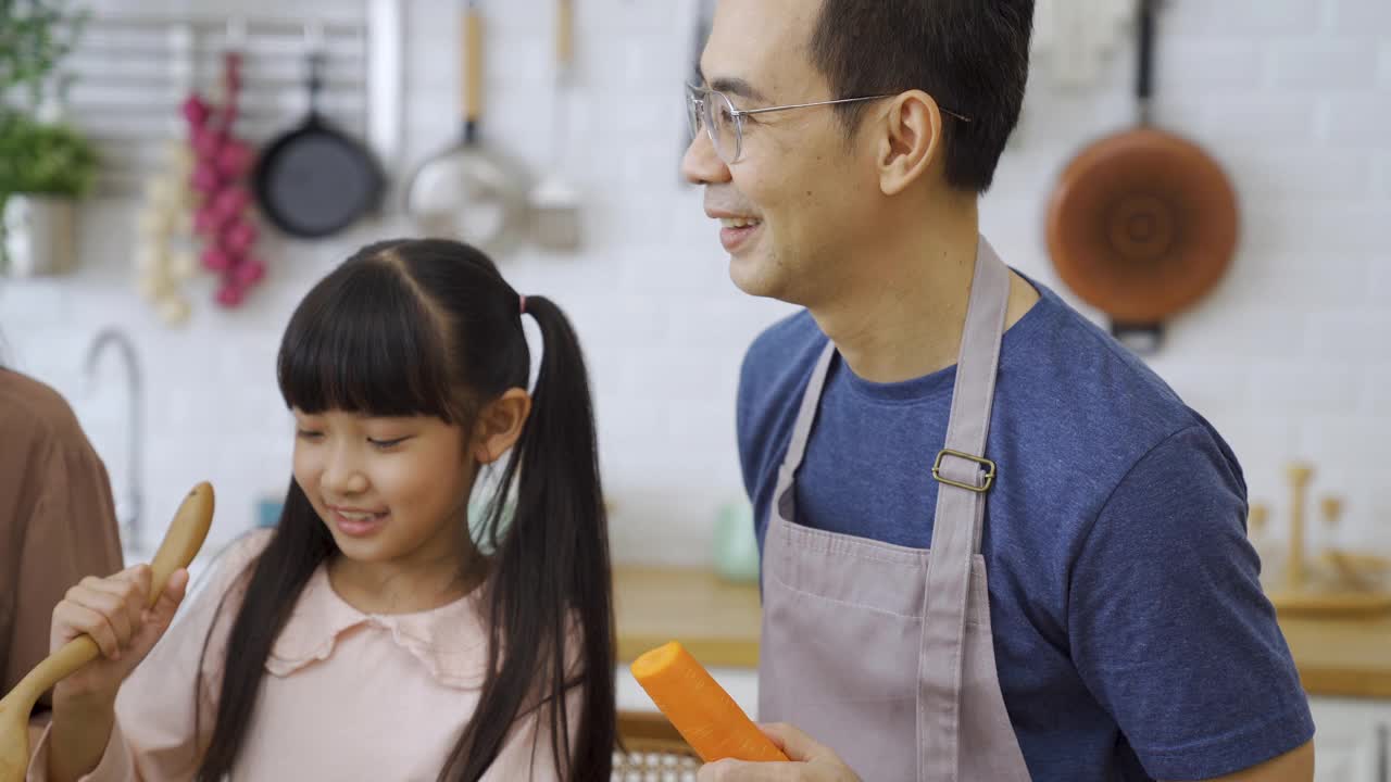 幸福的家庭，妈妈，爸爸，孩子，兄弟姐妹一起做饭。视频素材