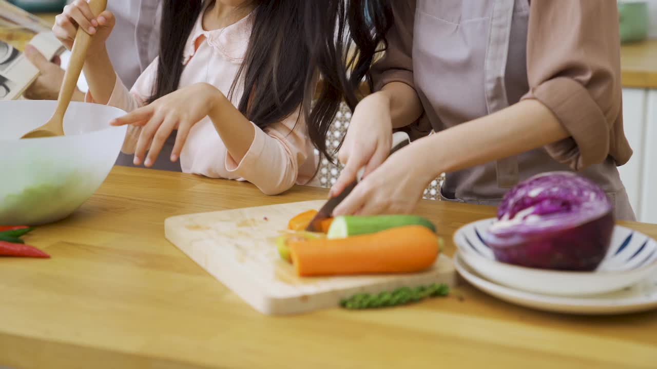 假日一家人在厨房一起做午餐。视频素材