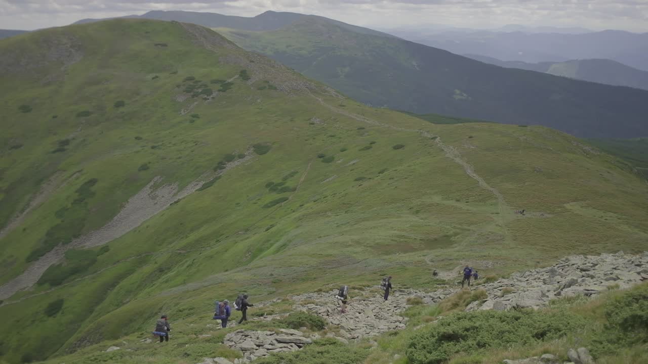 一群背着背包在山上徒步旅行的游客。视频素材