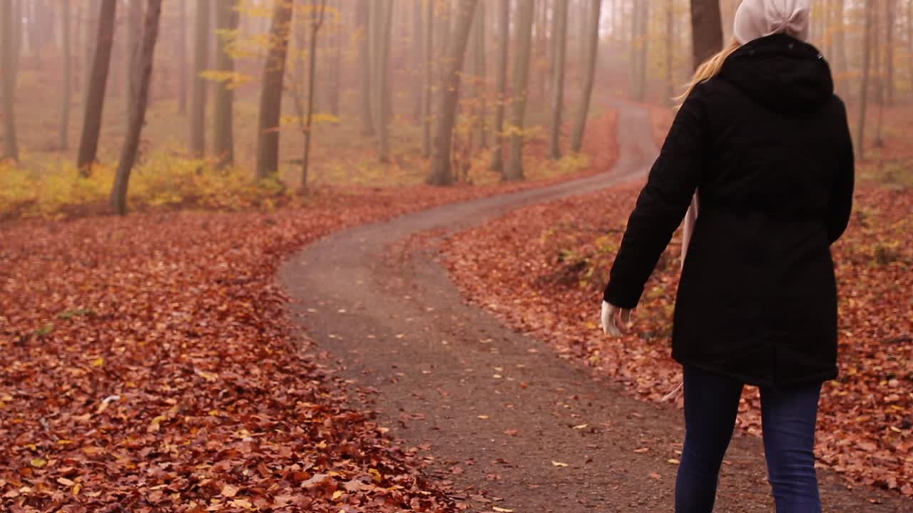 快乐的女人在雾蒙蒙的森林里散步跳舞视频素材