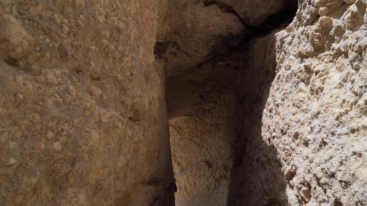 沿着葡萄牙海岸阿尔加维区(Carvoeiro)的山石小径和隧道行走。视频素材