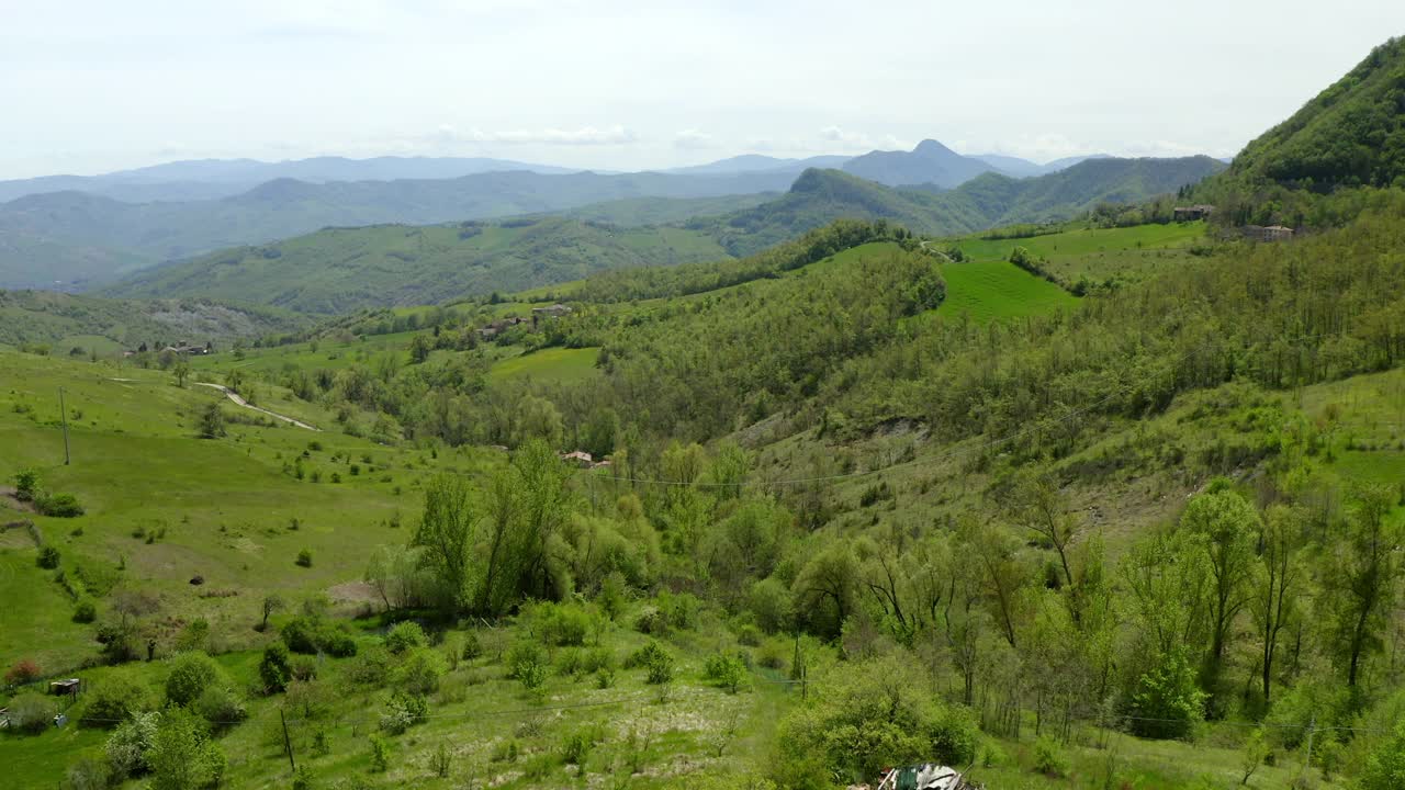 在多云的天空下的绿色小山的空中风景，无人机在植物上飞行前进-亚平宁山脉，意大利视频素材