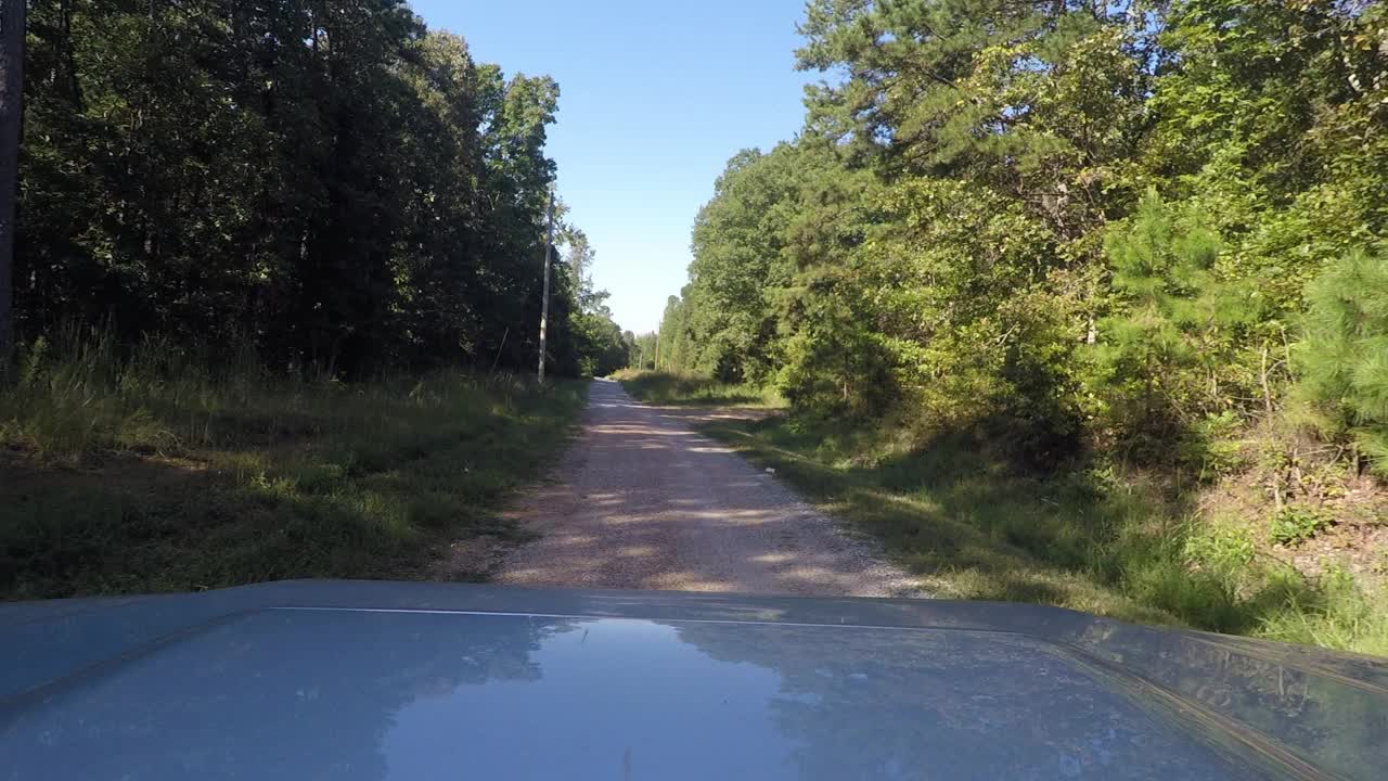 开车从铺好的道路进入泥泞的国家森林公路视频素材