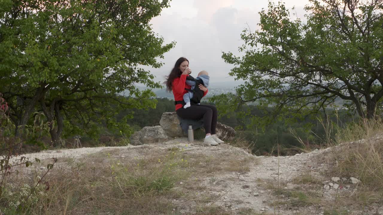 母亲带着宝宝在户外旅行，享受美景，家庭积极健康的生活方式，带着孩子的妇女，在俄罗斯克里米亚度假。视频素材