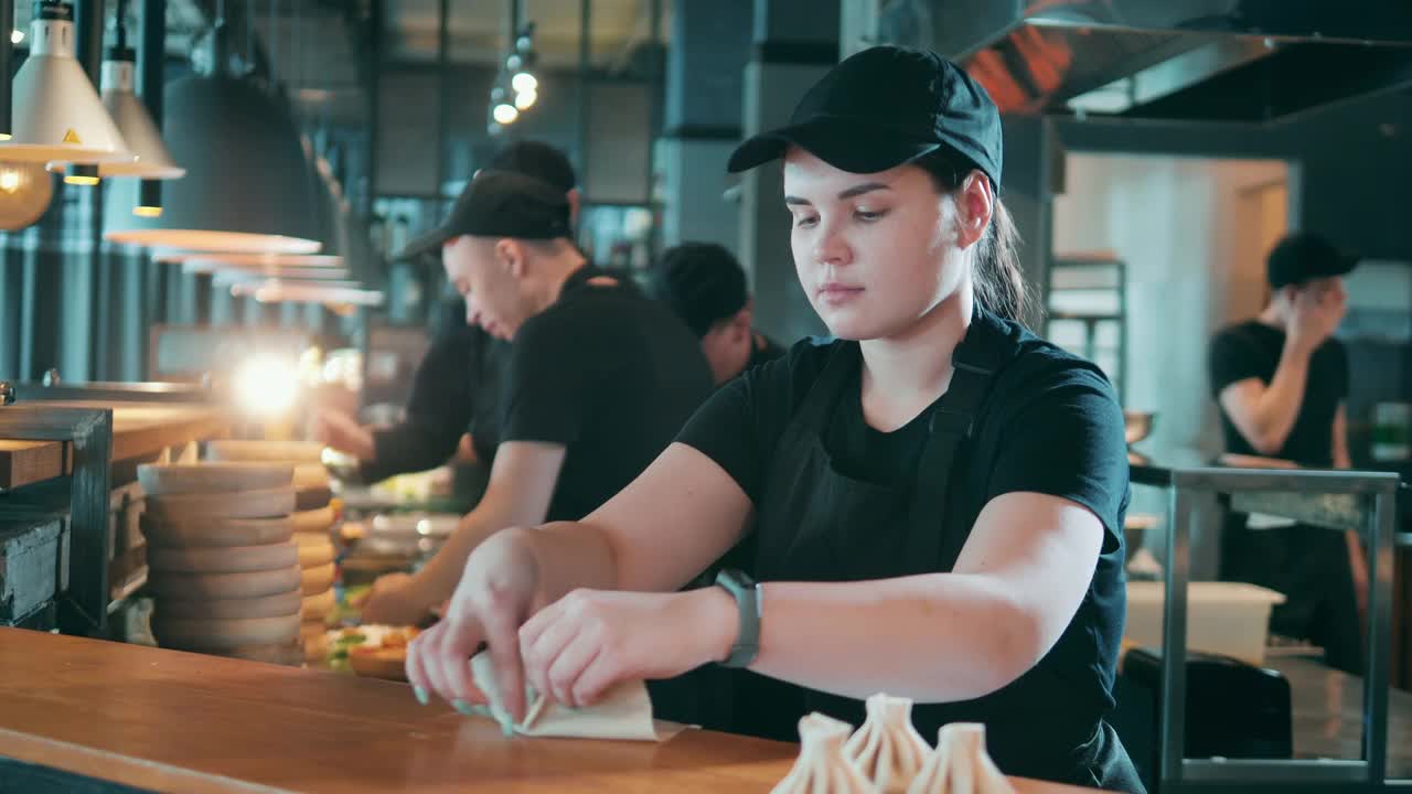 女厨师正在餐馆柜台上捏饺子视频素材