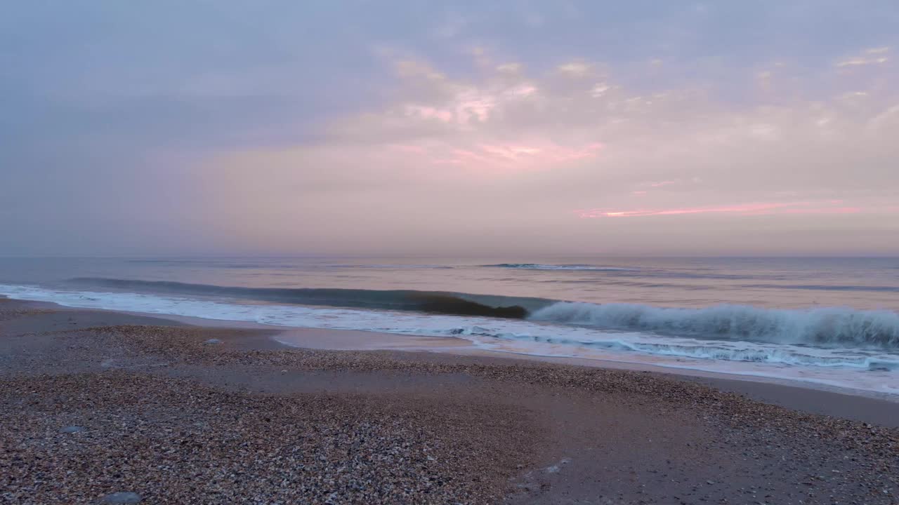 波在海滩。海上日出。在美丽的日落时分，海浪到达了沙滩视频素材