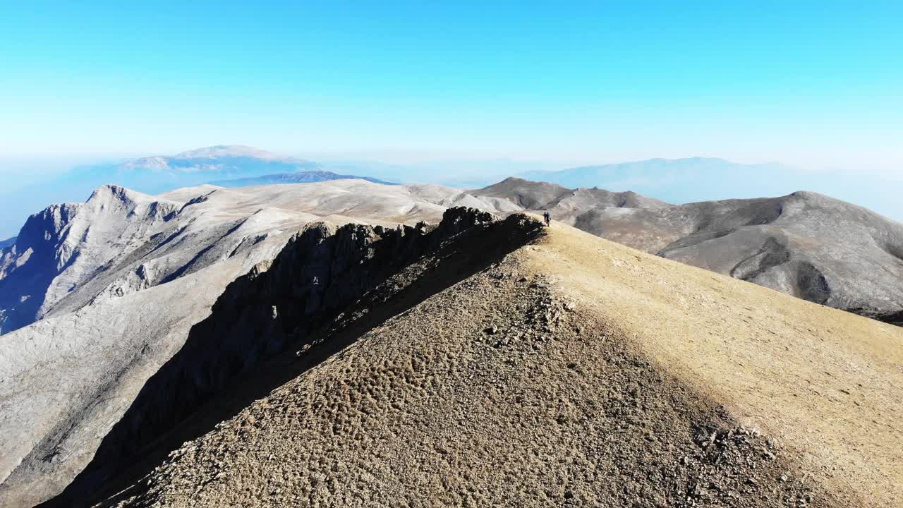 无人机拍摄的成功登山队正在攀登山脊的山顶。视频素材