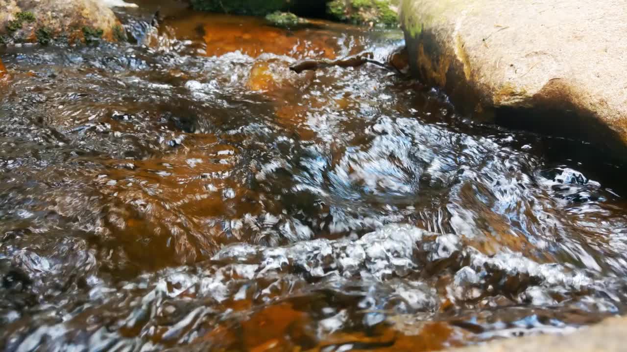 石头间流淌着清澈底的冷水视频素材