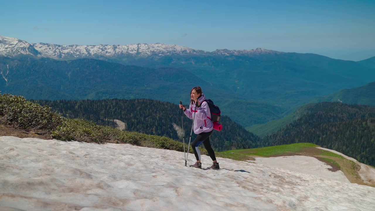 女登山运动员攀登危险而滑的山坡视频素材