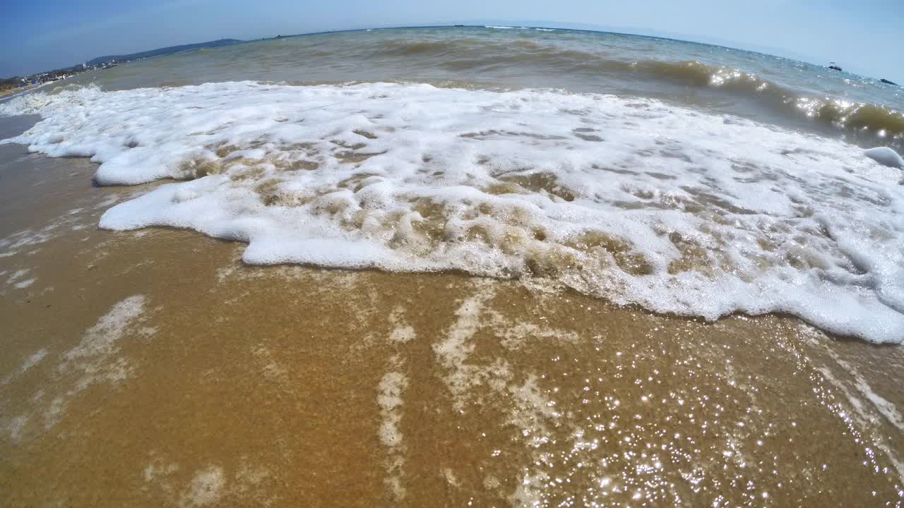 海浪卷上白色沙滩的特写镜头视频素材