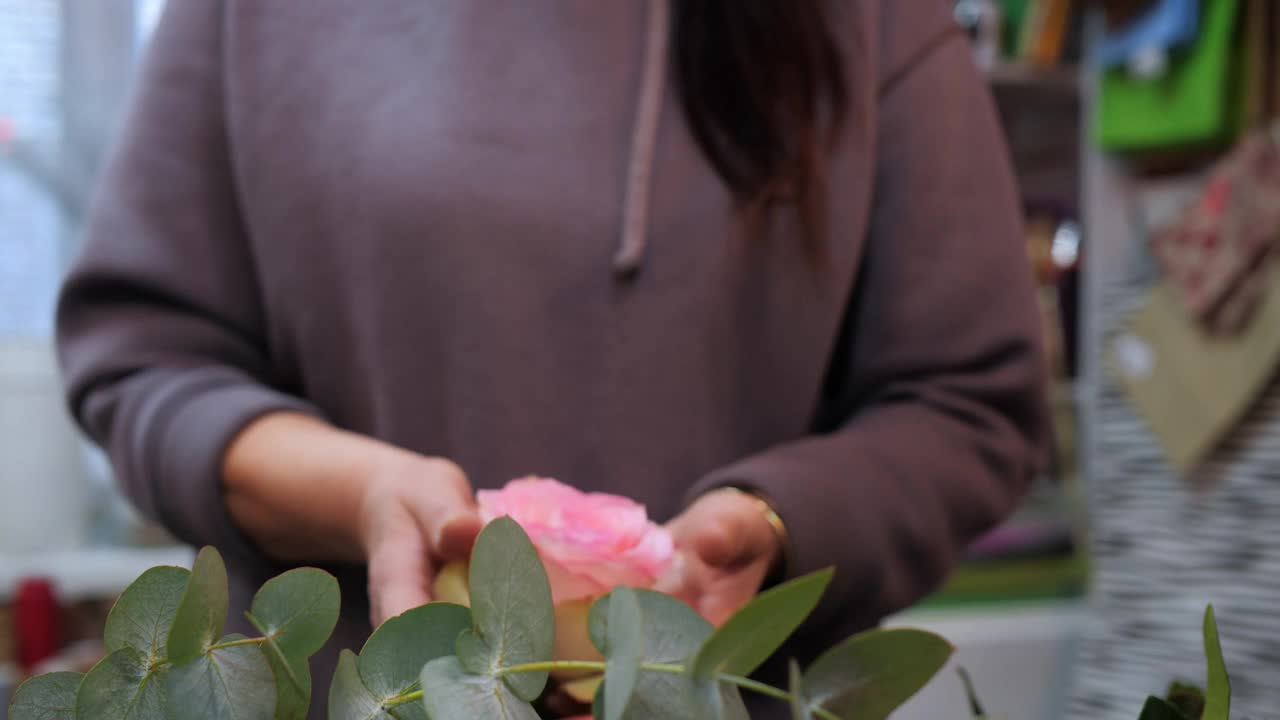 特写女子手持美丽的粉红色玫瑰头在手掌上视频素材