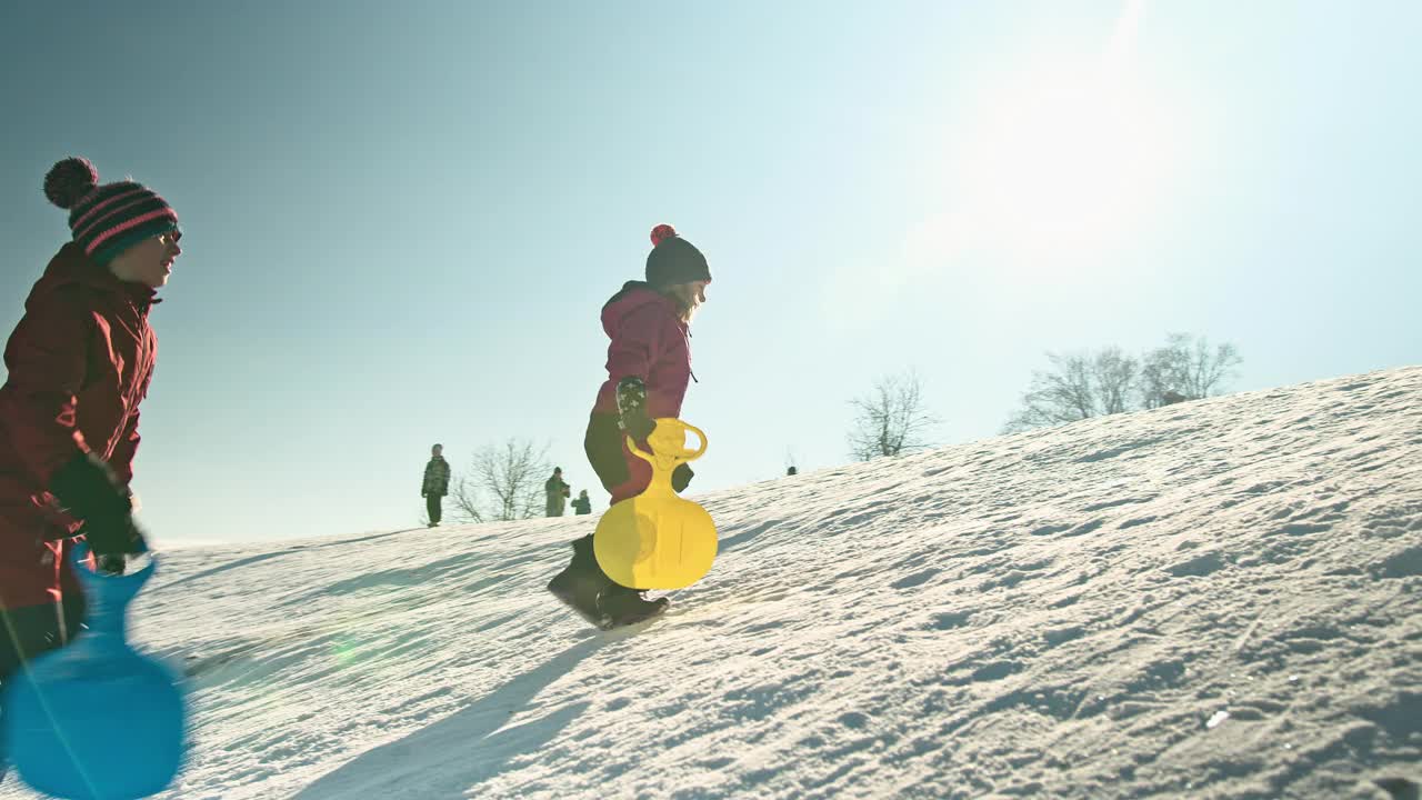 一家人在山上玩雪橇视频素材