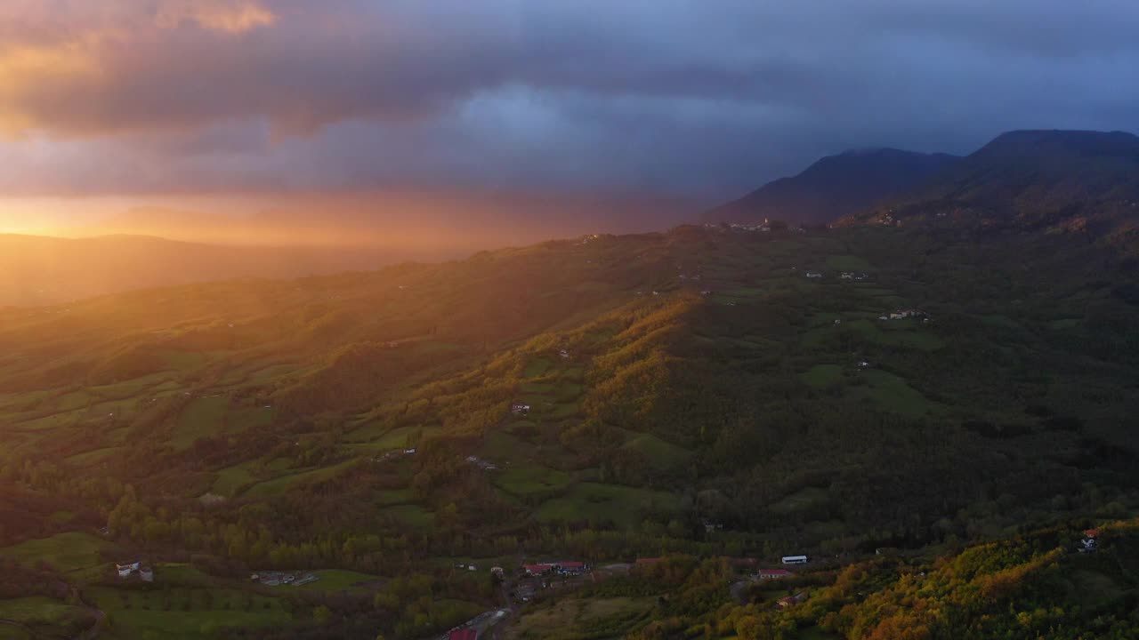 空中前进田园诗的照片在绿色的小山在多云的天空在日落-亚平宁山脉，意大利视频素材