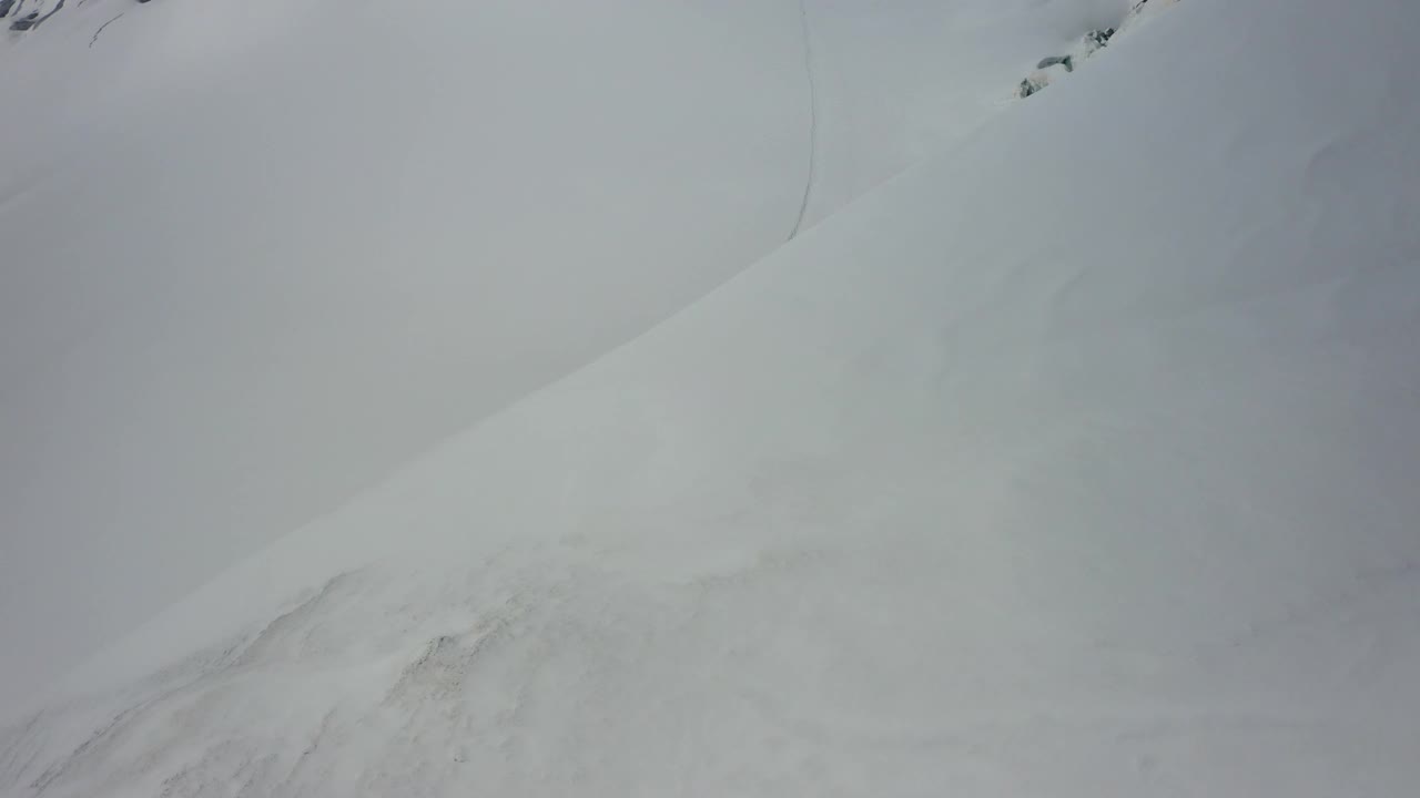 空中的人在冬季探索，无人机在冰雪覆盖的风景上飞行前进- Lauterbrunnen，瑞士视频素材