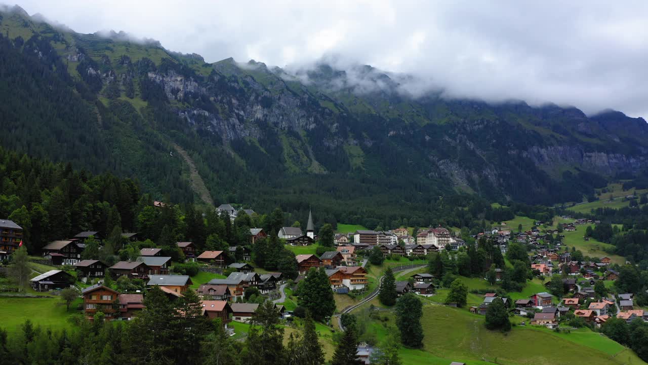 空中前进村庄住宅的美丽镜头，无人机飞过绿色景观- Lauterbrunnen，瑞士视频素材