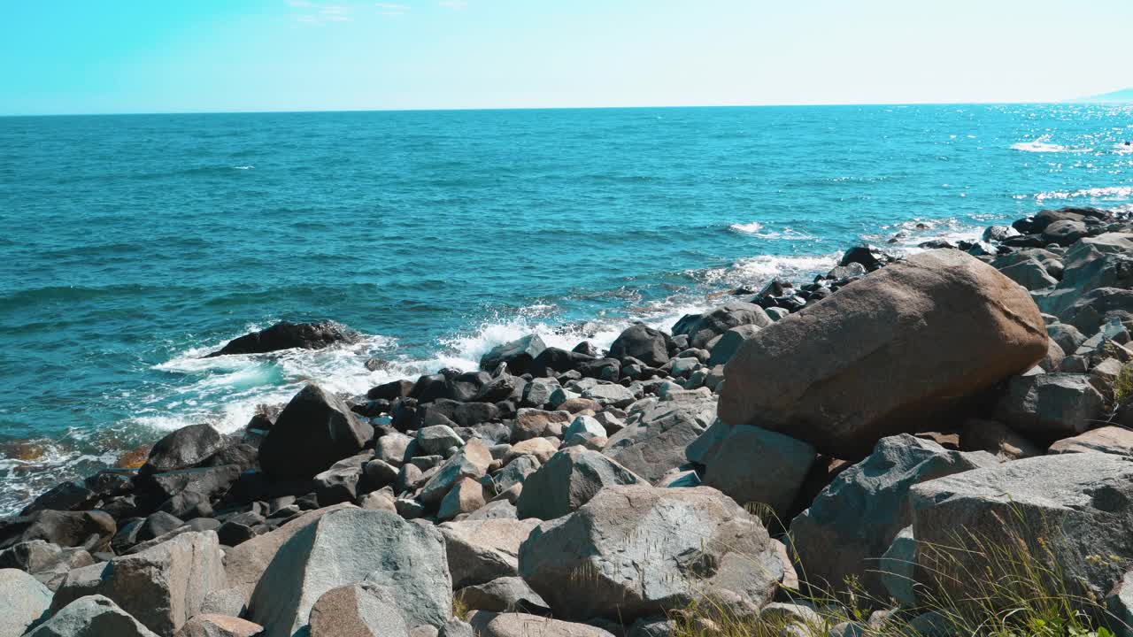 荒芜荒芜的海岸有着巨大的岩石和海浪视频素材