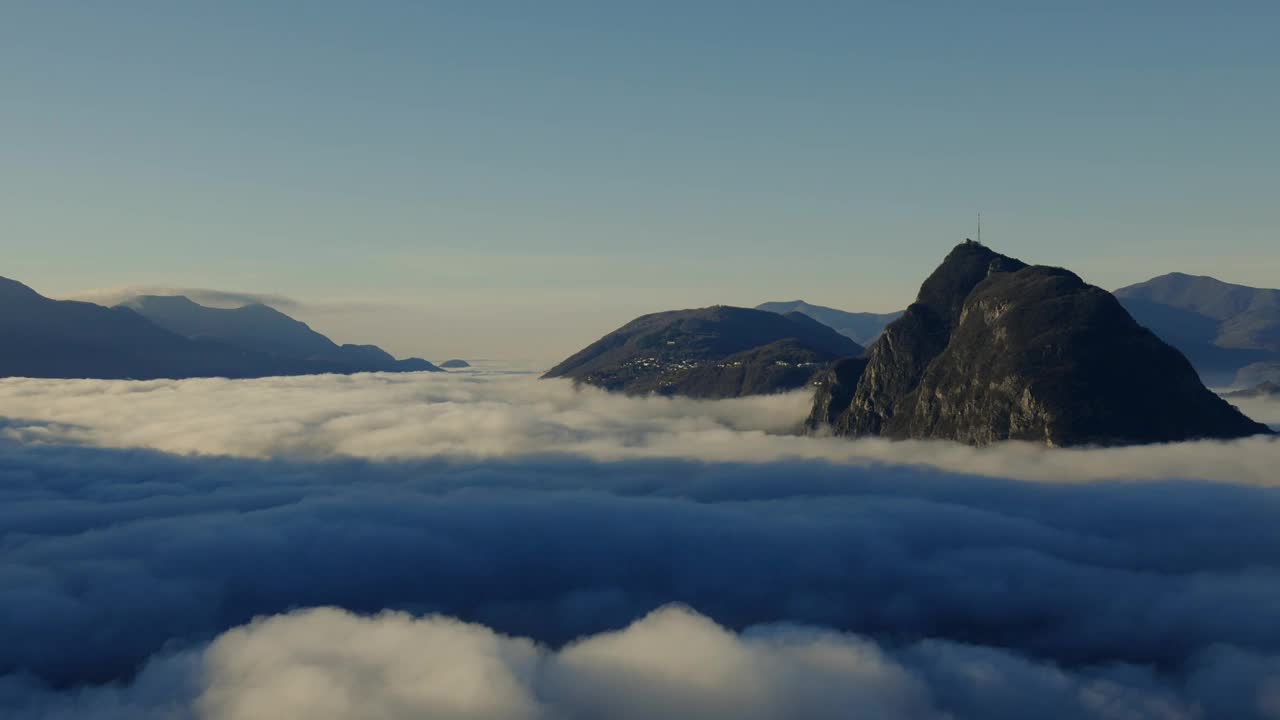 在阳光明媚的日子里，卢加诺市的云海和卢加诺高山湖视频素材