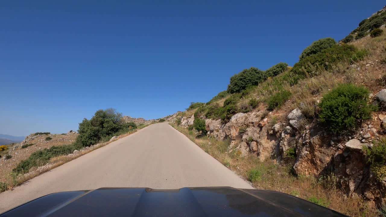 POV汽车行驶在笔直的两路旧沥青公路通过一座山在西班牙视频素材