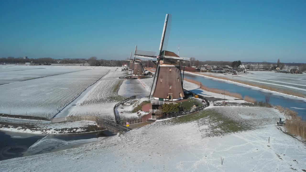 空中拍摄的Molendriegang Drie Molens在海牙附近被厚厚的积雪覆盖视频素材