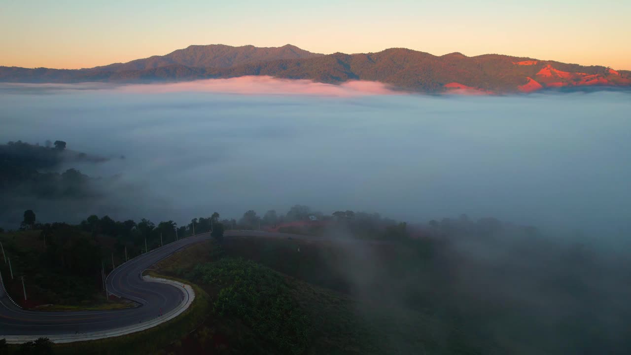 4K雾中的高山路。烟雾弥漫的热带森林。无人机鸟瞰图视频素材