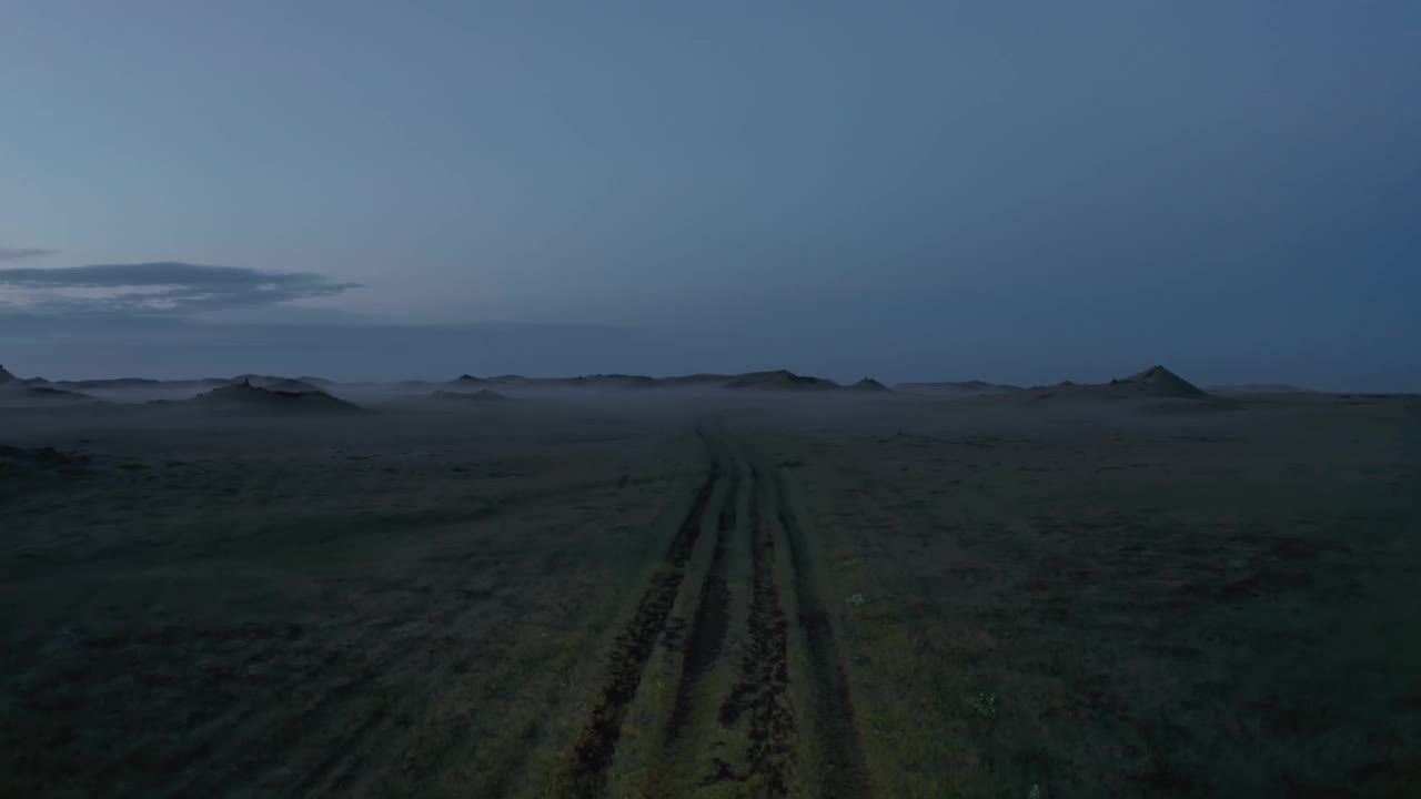 鸟瞰图飞向冒险的汽车驾驶在冰岛乡村的野外小径。商业航拍的游客在冰岛的格陵兰岛夜间公路观光荒野视频素材