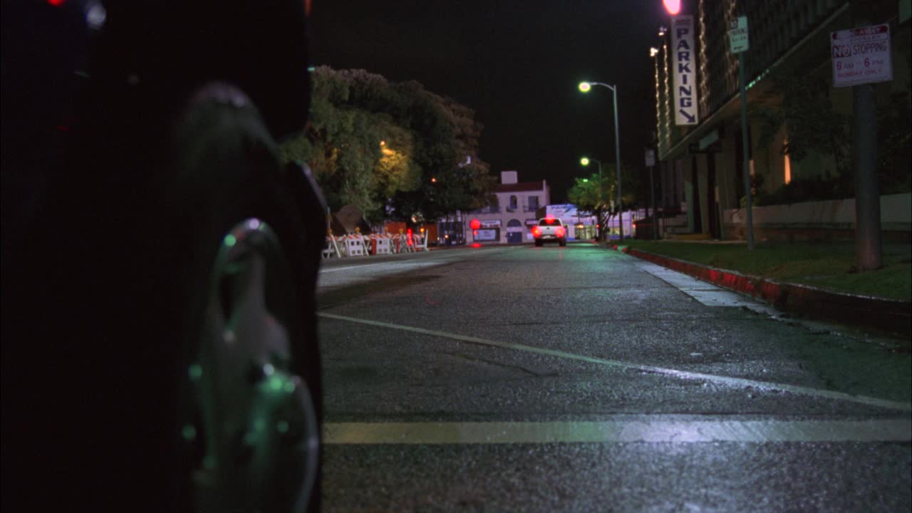 在被雨水冲刷的城市街道上，货车或越野车的轮胎的特写角度。货车突然转向，差点撞到闪着灯的停车护栏上。汽车特技表演。轮毂。可以是建筑区域。视频素材