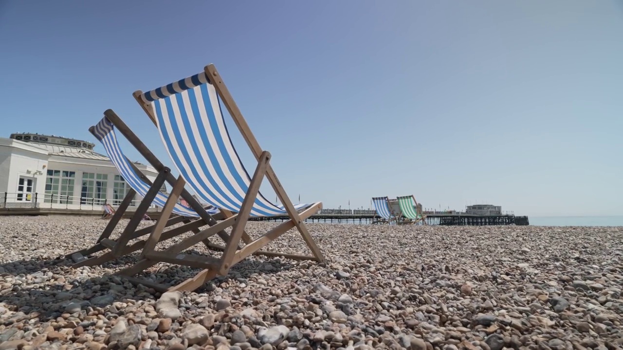 夏天在海滩和Worthing码头的躺椅，Worthing，西苏塞克斯，英格兰，英国，欧洲视频素材