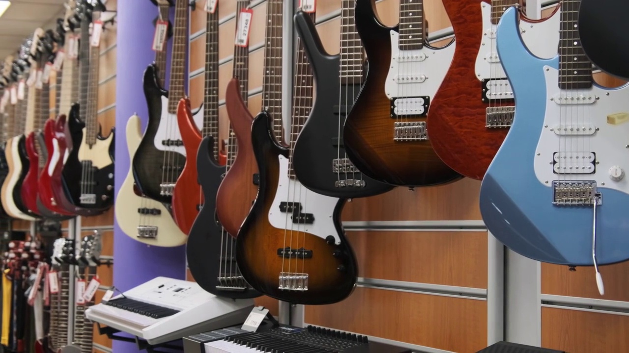 许多彩色电吉他挂在一个音乐商店，吉他店视频素材
