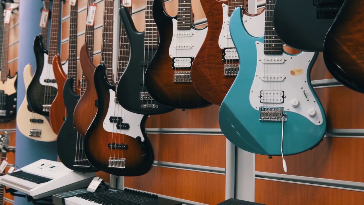 商店里出售许多新款、不同颜色的电吉他视频素材