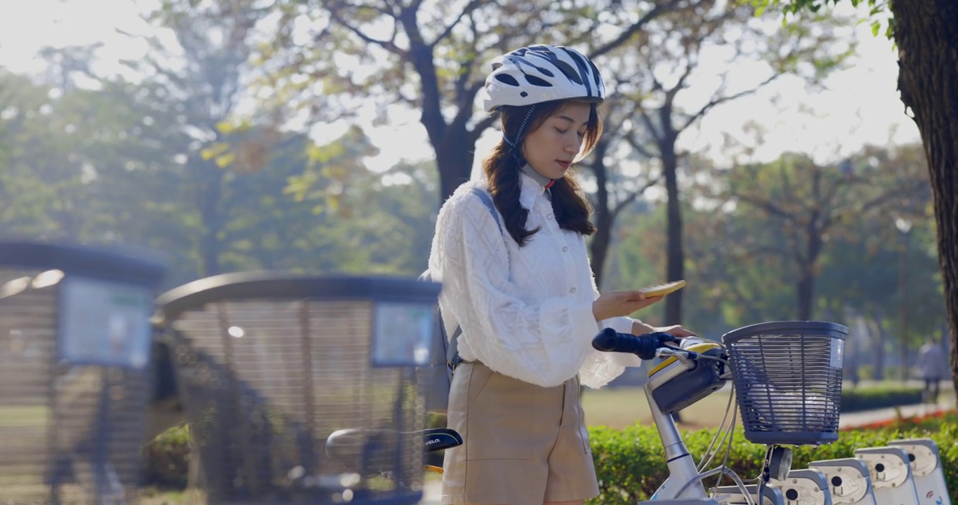 亚洲女商人在市中心租用共享自行车上班或上班视频素材