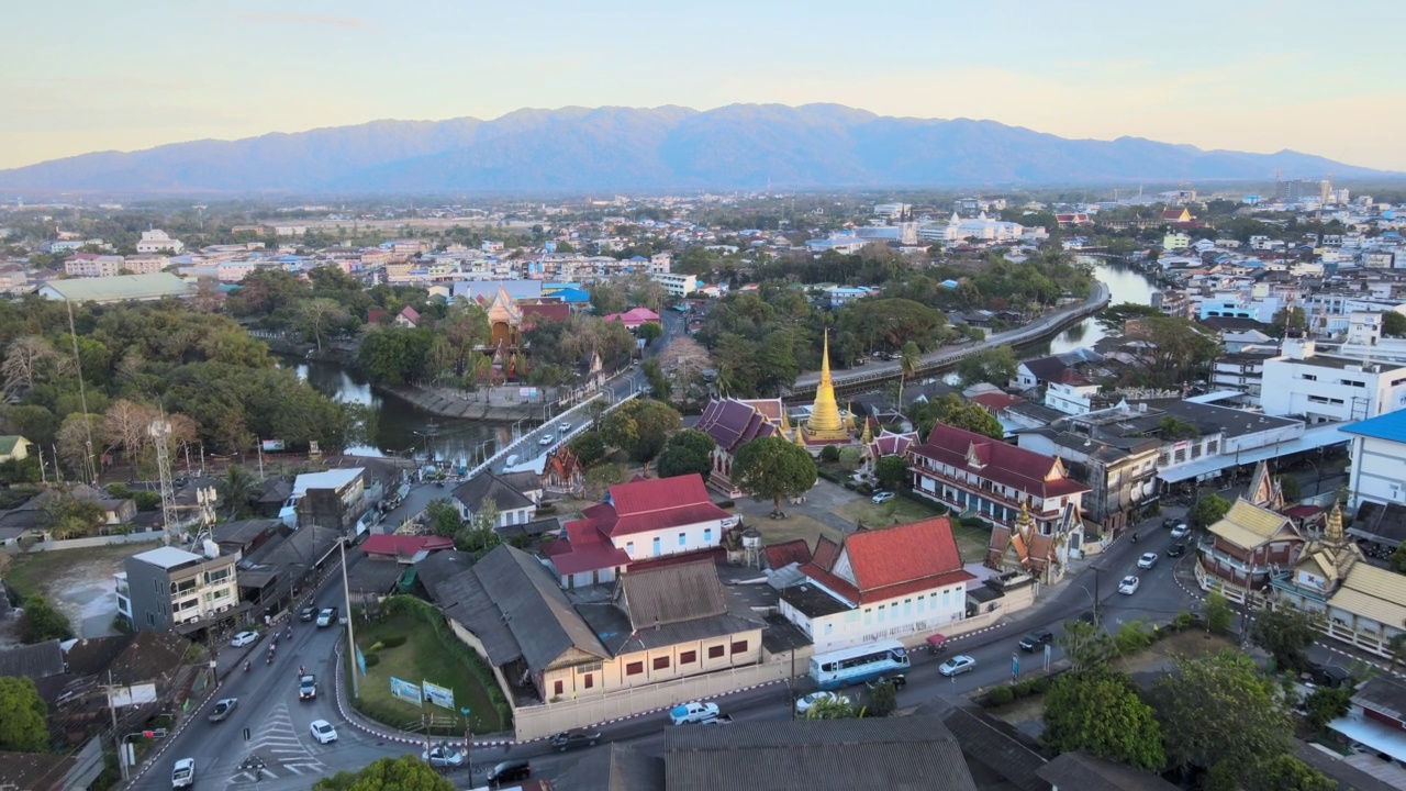 Chanthaboon滨水区(Aerial-Drone VDO) -日落时分沿河的泰国寺庙和古老的木屋。视频素材