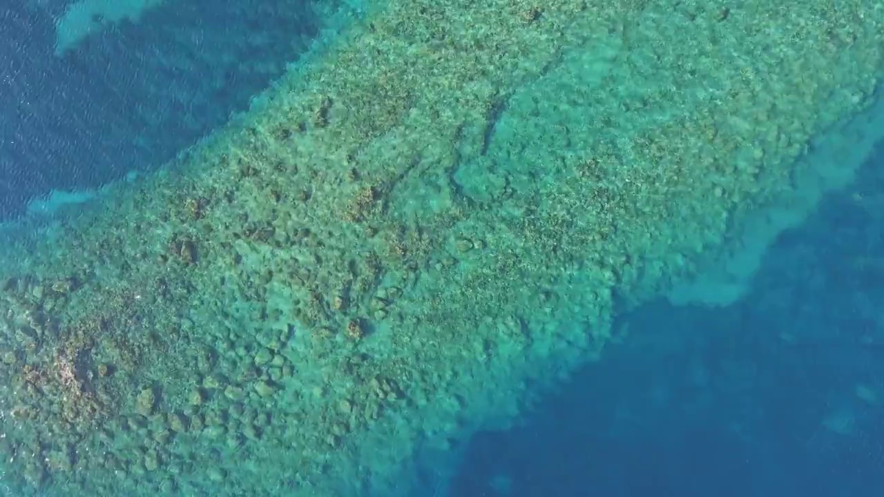 俯视图透明浅绿松石海洋，海水表面和岩石视频素材