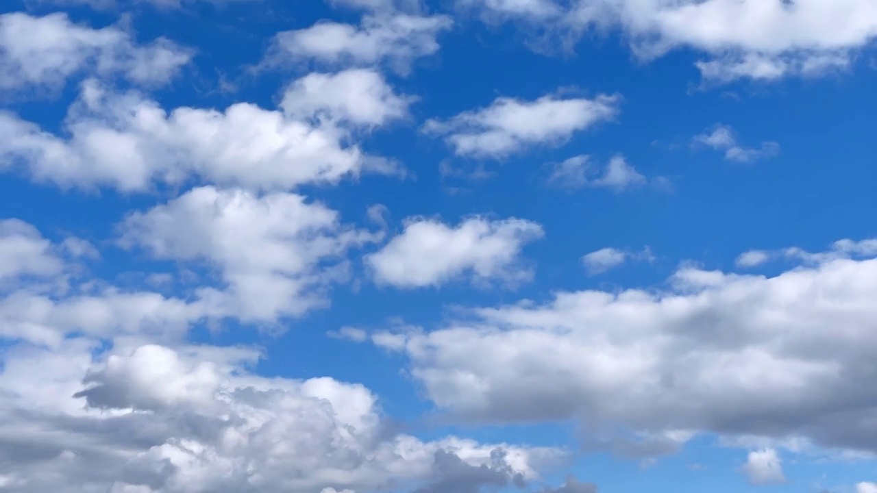 一簇积云在蓝天上扩散和漂移的镜头。Cloudscape在日本视频素材