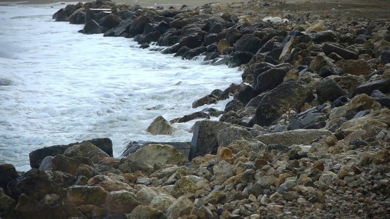 冲击海岸的海浪中充满了巨石视频素材